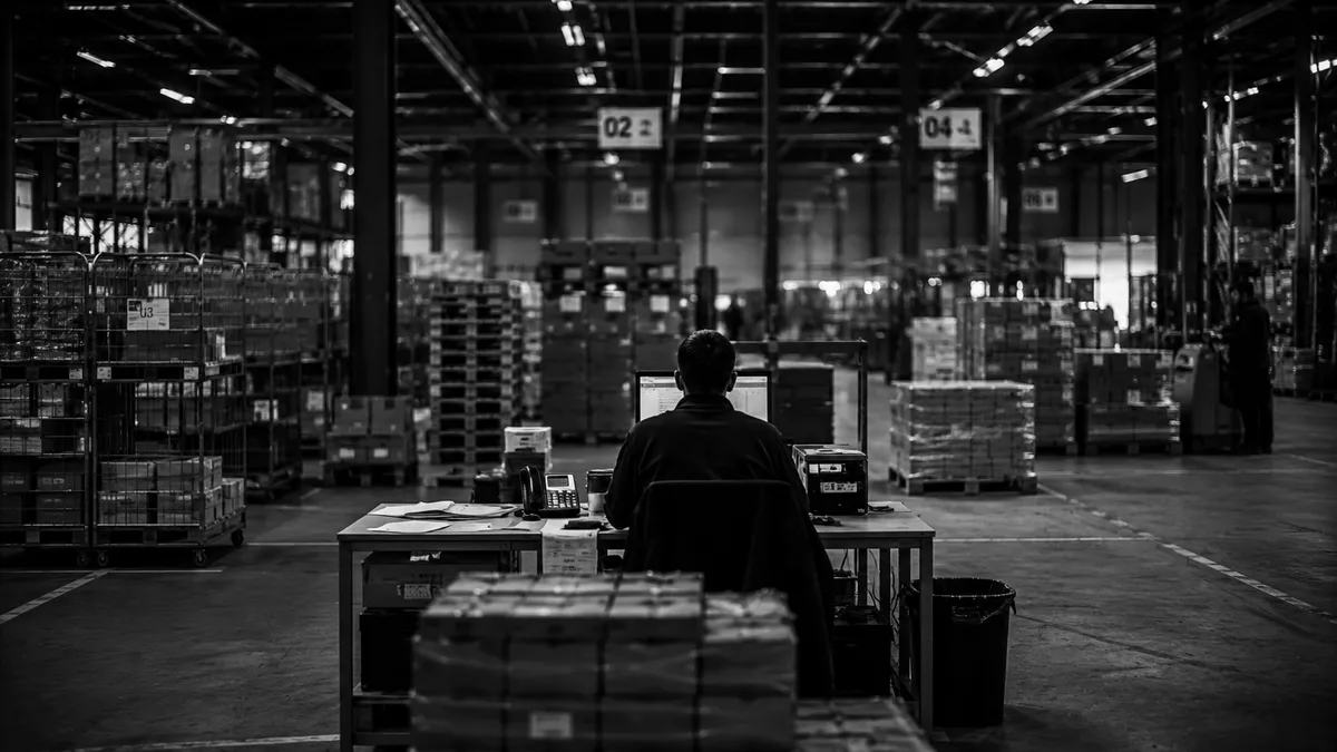 Experienced employee explaining something to a colleague on the warehouse floor